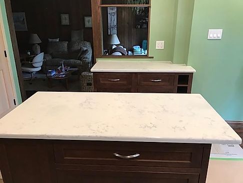 White Marble Table top with wooden cabinets and drawers.